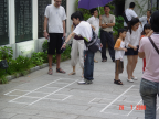 Photo of parents teaching the children to play 'cit-cit chom'