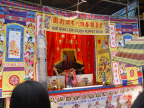 Photo of puppet show on stage opposite the temple